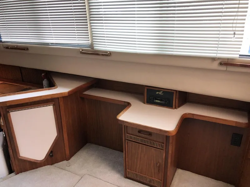 Slide: The Image of 1987 Sea Ray 360 Aft Cabin interior with wood cabinetry and blinds. - 16