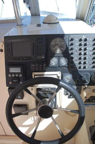 Slide: The Image of 1997 Albin 28 Tournament boat dashboard with steering wheel and navigation instruments. - 13