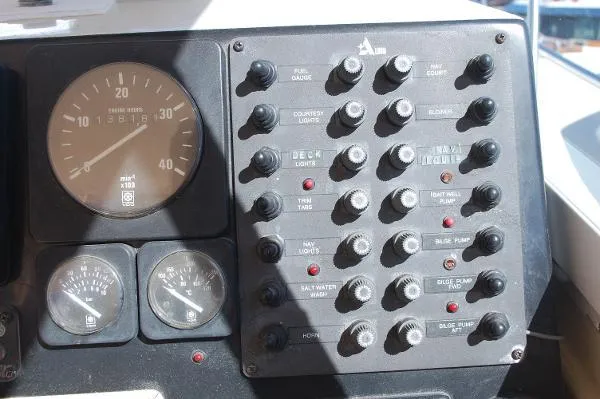 Slide: The Image of Control panel of a 1997 Albin 28 Tournament boat with gauges and switches. - 14