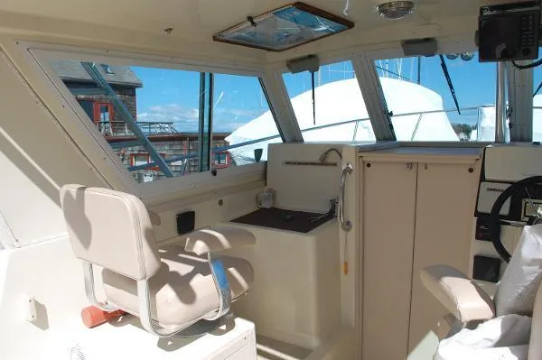 Slide: The Image of Interior of 1997 Albin 28 Tournament boat, featuring helm and seating area. - 15