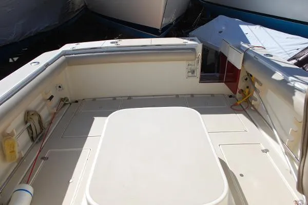 Slide: The Image of 1997 Albin 28 Tournament boat deck, spacious and well-maintained, with storage compartments. - 18