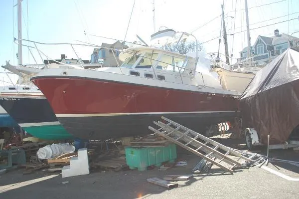 Slide: The Image of 1997 Albin 28 Tournament boat in dry dock, red hull, marina setting. - 20