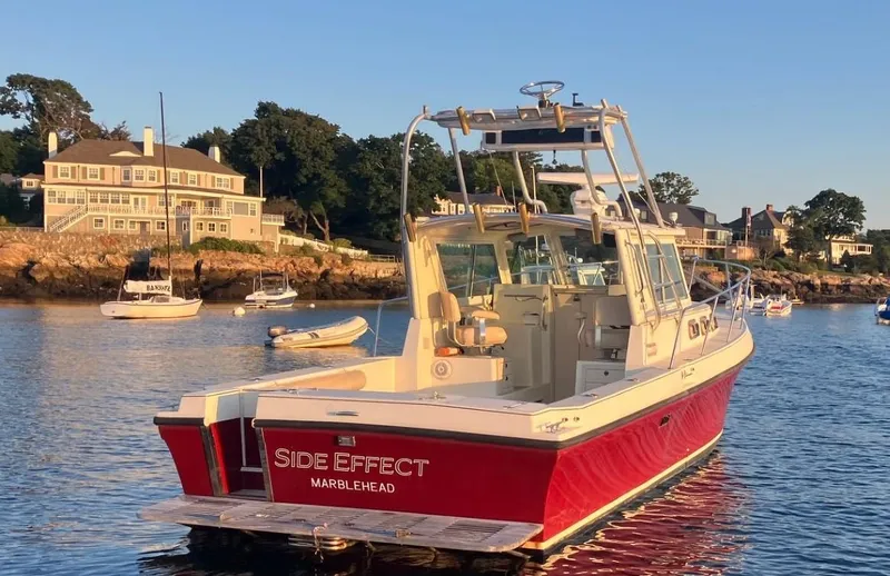 Slide: The Image of Red 1997 Albin 28 Tournament boat named "Side Effect" docked in a scenic harbor. - 3