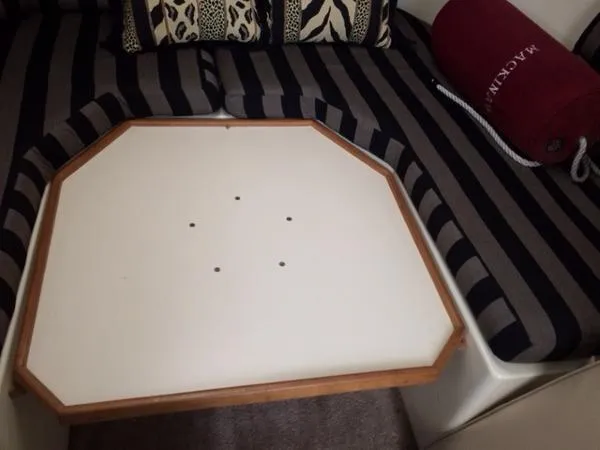 Slide: The Image of 1997 Albin 28 Tournament interior with striped seating and hexagonal table. - 7