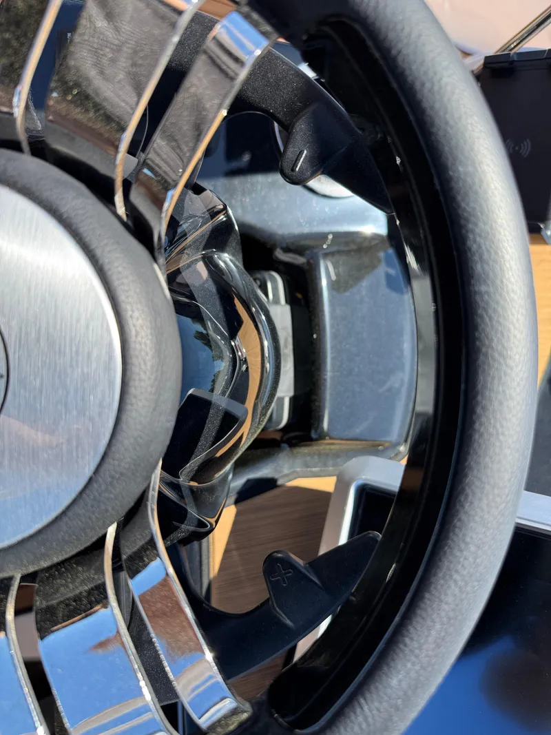 Slide: The Image of Steering wheel of 2025 Yamaha Boats 222SD, featuring sleek chrome and leather design. - 15