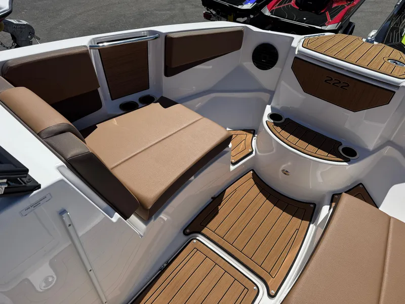 Slide: The Image of 2025 Yamaha Boats 222SD interior with brown seating and wood-style flooring. - 18