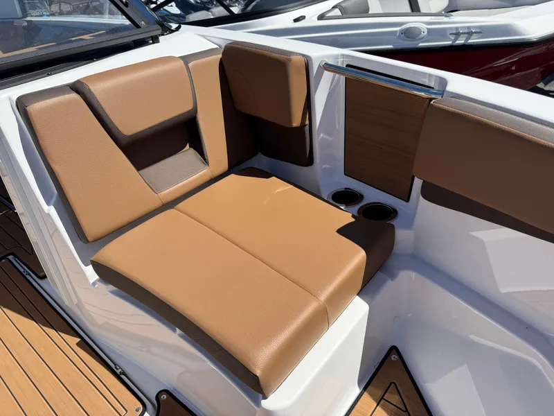Slide: The Image of 2025 Yamaha Boats 222SD interior seating with brown upholstery and cup holders. - 22