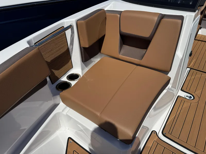 Slide: The Image of 2025 Yamaha Boats 222SD interior with brown seating and cup holders. - 23