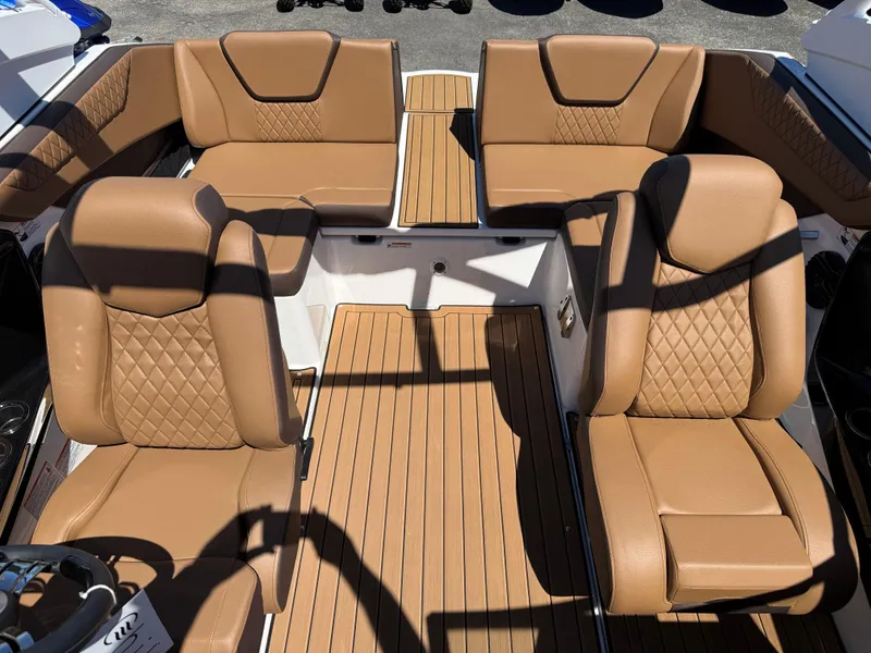 Slide: The Image of Luxurious interior of 2025 Yamaha Boats 222SD with tan leather seating and wood flooring. - 25