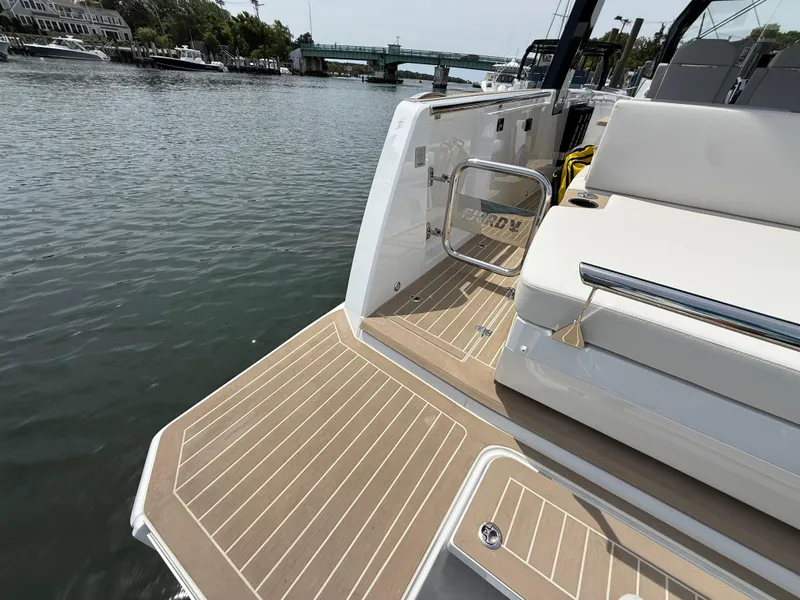 Slide: The Image of 2025 Fjord 39 XP yacht deck with elegant seating, docked by a serene waterfront. - 13