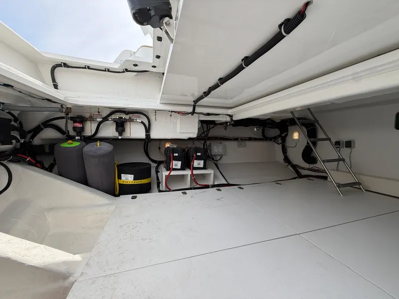 Slide: The Image of Engine compartment of 2025 Fjord 39 XP yacht, showcasing wiring and storage space. - 19