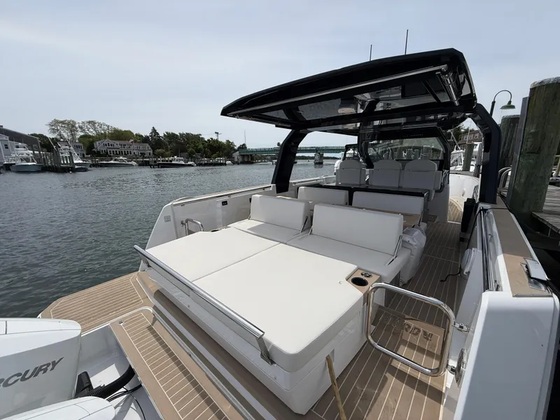 Slide: The Image of 2025 Fjord 39 XP yacht with spacious deck, docked by a scenic waterfront. - 22