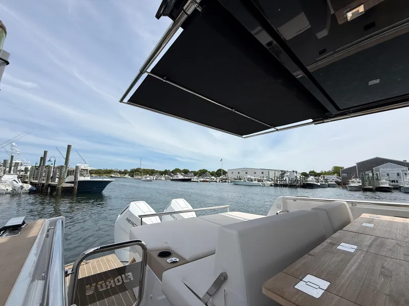 Slide: The Image of 2025 Fjord 39 XP yacht with open deck, docked at marina under clear sky. - 24