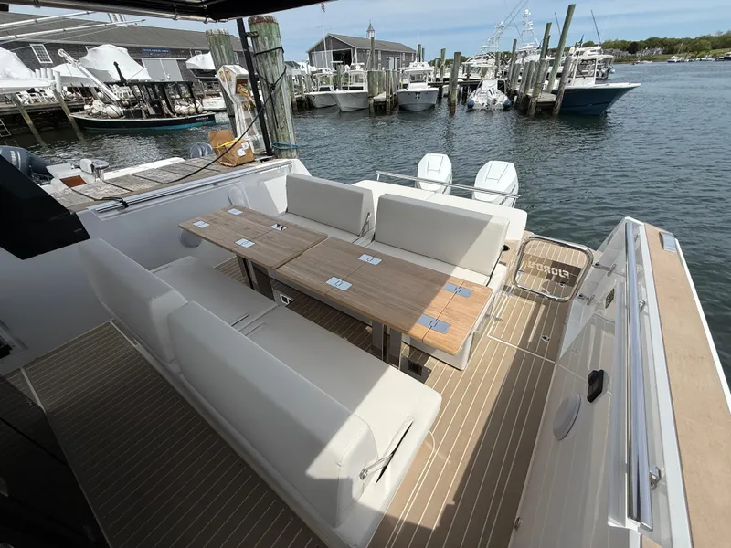 Slide: The Image of 2025 Fjord 39 XP yacht with spacious deck seating and table, docked at a marina. - 27