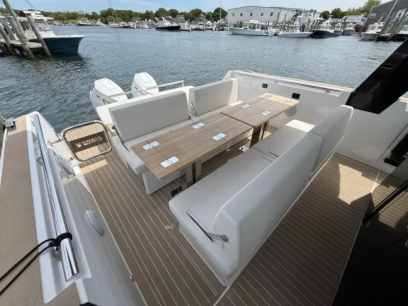 Slide: The Image of 2025 Fjord 39 XP yacht with outdoor seating and table, docked at a marina. - 28