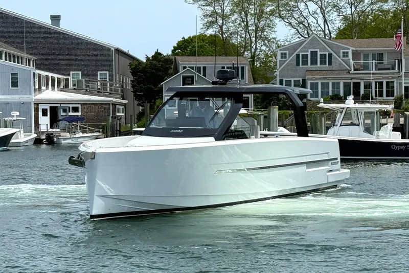 Slide: The Image of 2025 Fjord 39 XP yacht cruising in a scenic harbor with waterfront homes. - 3
