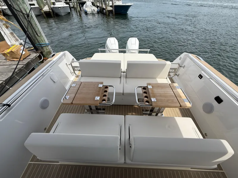 Slide: The Image of 2025 Fjord 39 XP yacht deck with seating and tables, docked by the water. - 33