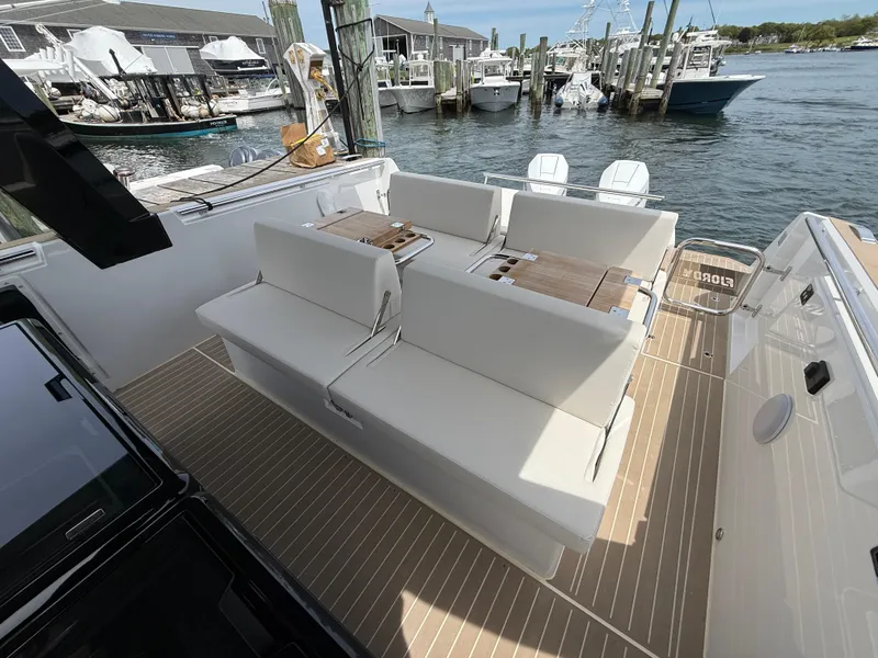 Slide: The Image of 2025 Fjord 39 XP yacht with sleek seating, docked at a marina. - 36