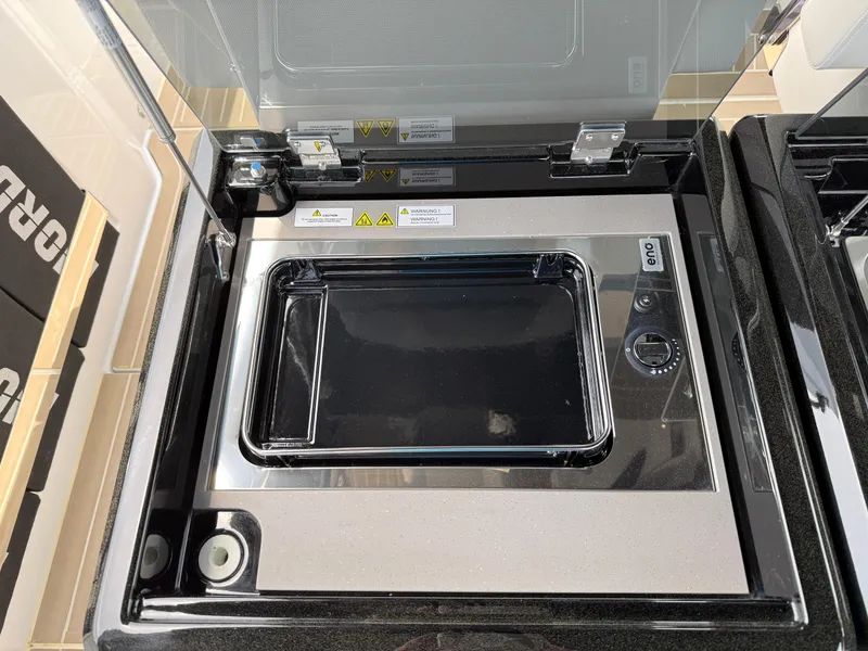 Slide: The Image of 2025 Fjord 39 XP yacht kitchen appliance with sleek black and silver design. - 40