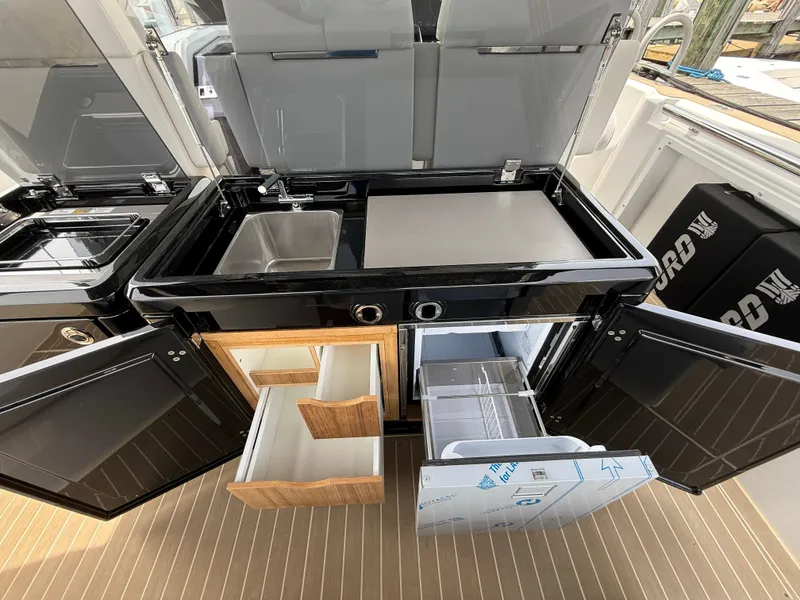 Slide: The Image of Outdoor kitchen on 2025 Fjord 39 XP yacht with sink, grill, and storage drawers. - 42