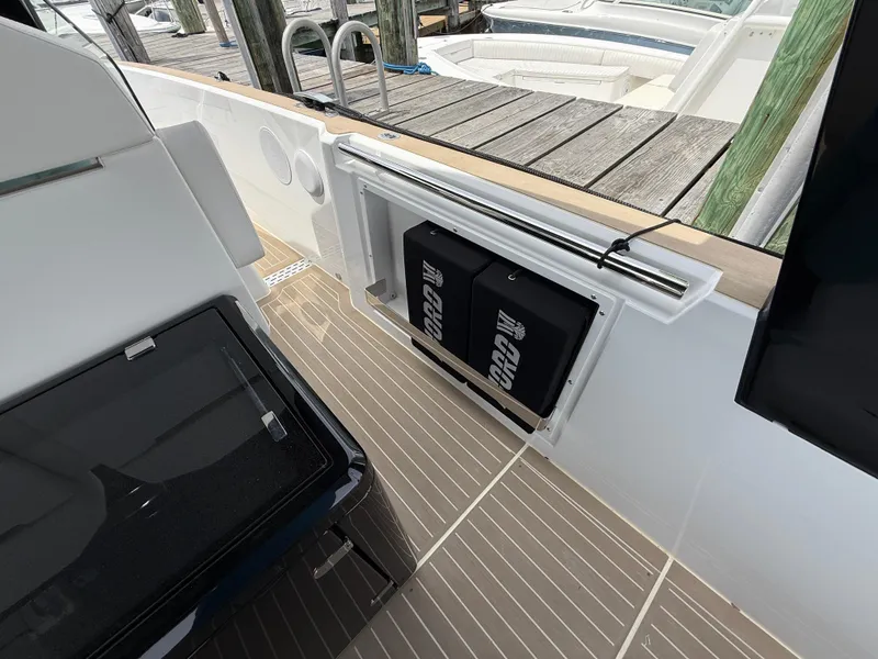 Slide: The Image of 2025 Fjord 39 XP boat interior with storage compartments and dock view. - 46