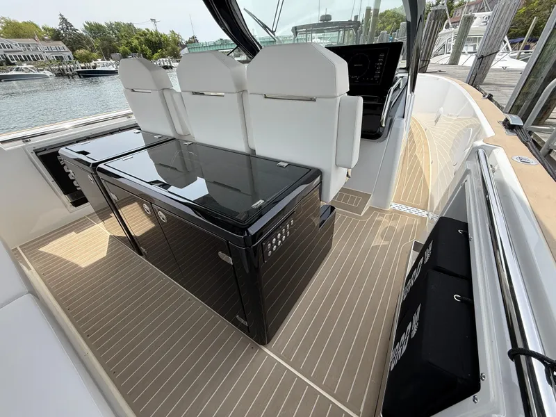 Slide: The Image of Modern 2025 Fjord 39 XP yacht interior with sleek seating and glass table, docked at marina. - 47