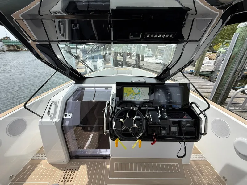 Slide: The Image of Helm of 2025 Fjord 39 XP boat with modern navigation system and steering wheel. - 49
