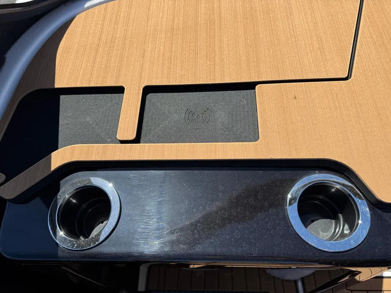 Slide: The Image of Yamaha Boats 2025 222SD dashboard with cup holders and wireless charging pad. - 10