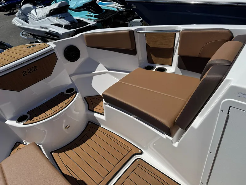 Slide: The Image of 2025 Yamaha Boats 222SD interior with brown seating and wood accents. - 20