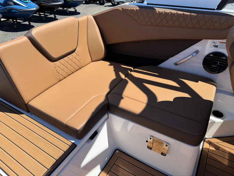 Slide: The Image of 2025 Yamaha Boats 222SD interior with tan seating and wood accents. - 29
