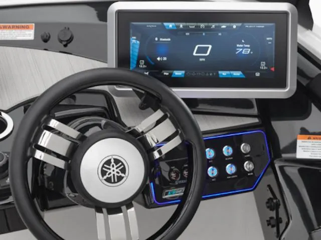 Slide: The Image of Steering wheel and dashboard of 2025 Yamaha Boats 222SD, featuring modern digital display. - 41
