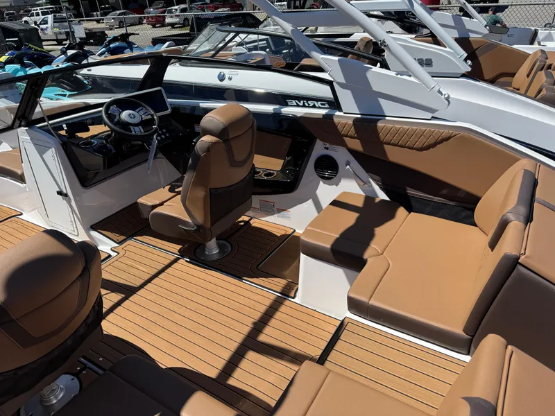 Slide: The Image of 2025 Yamaha Boats 222SD interior with tan seating and modern dashboard. - 5