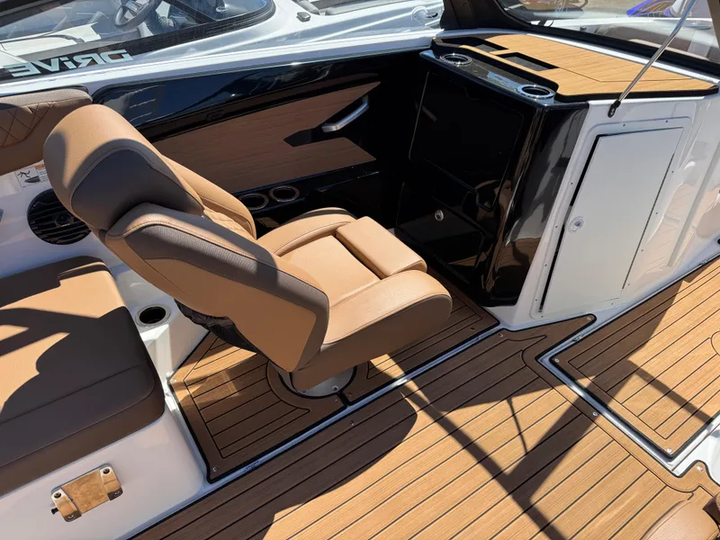 Slide: The Image of 2025 Yamaha Boats 222SD interior with tan seating and wood-style flooring. - 7