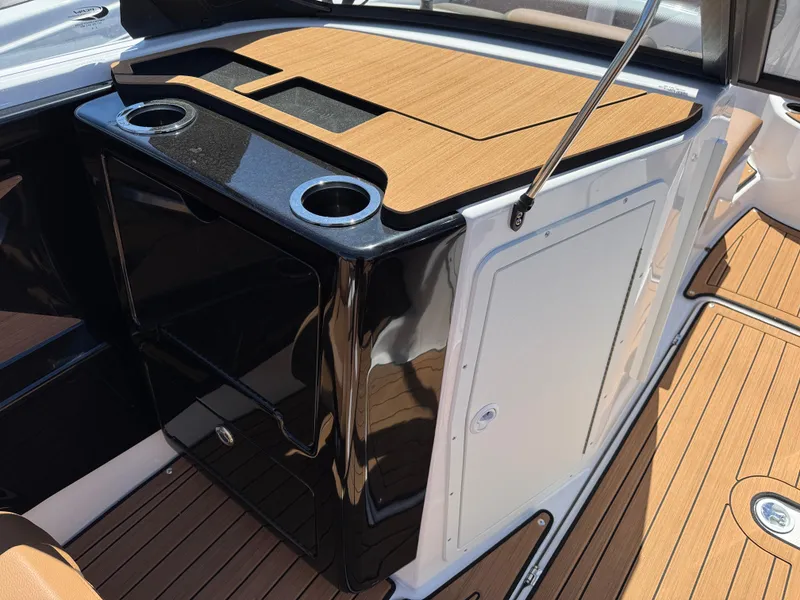 Slide: The Image of 2025 Yamaha Boats 222SD interior with sleek black console and wood accents. - 9