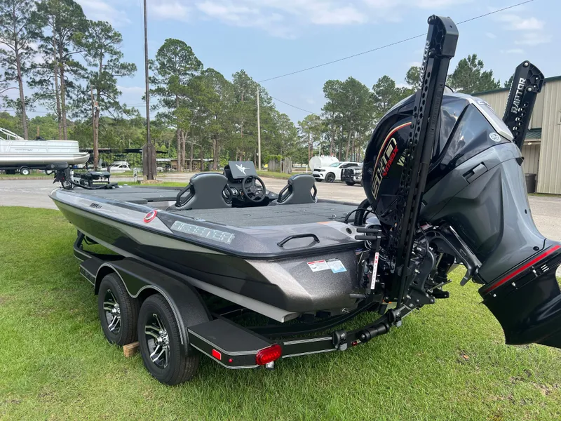 Slide: The Image of 2025 Skeeter ZXR 21 boat on trailer, parked on grass, with trees in the background. - 3