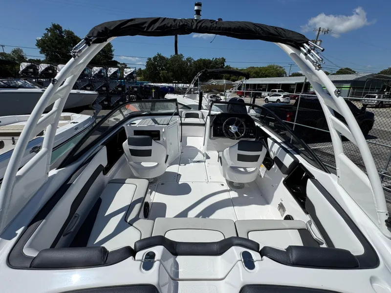 Slide: The Image of 2025 Yamaha Boats 195S interior, featuring sleek seating and modern design under a clear blue sky. - 3