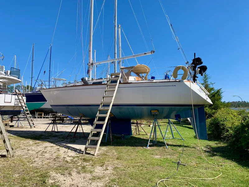 Slide: The Image of 1986 Sabre 36 sailboat on land with ladder and clear blue sky. - 1