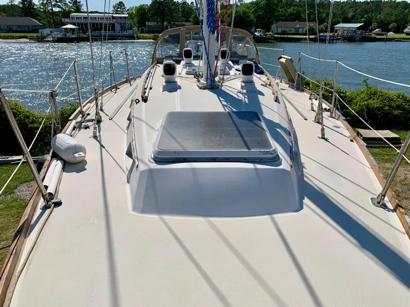Slide: The Image of Sailboat deck view of 1986 Sabre 36, docked by a scenic waterfront. - 10