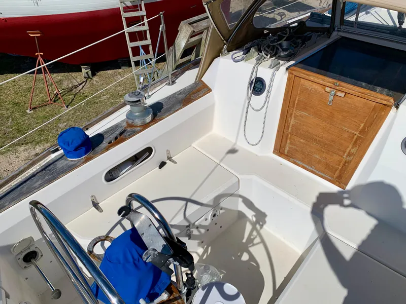 Slide: The Image of Cockpit of 1986 Sabre 36 sailboat with steering wheel, winch, and wooden hatch. - 18
