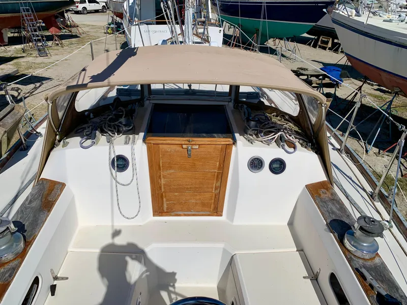 Slide: The Image of 1986 Sabre 36 sailboat cockpit with wooden hatch, canopy, and winches. - 19