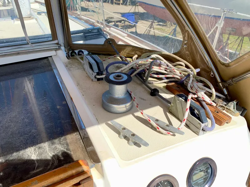 Slide: The Image of 1986 Sabre 36 sailboat cockpit with winch, ropes, and gauges in sunlight. - 20