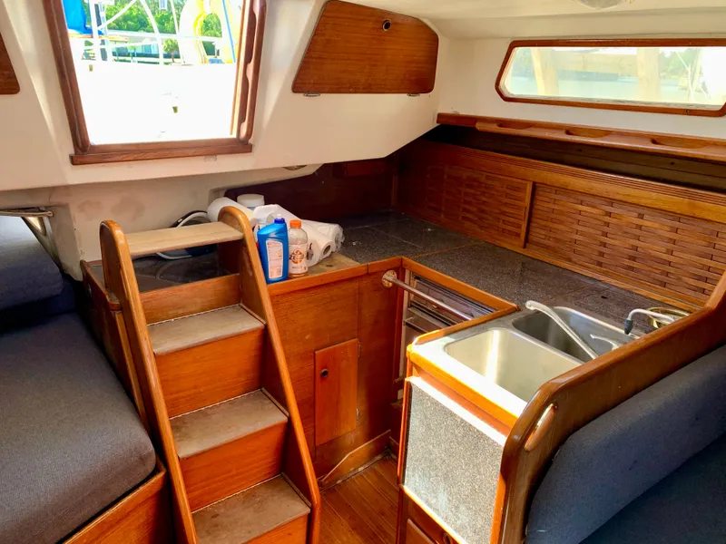 Slide: The Image of Interior of 1986 Sabre 36 sailboat with wooden cabinetry and compact kitchen area. - 24