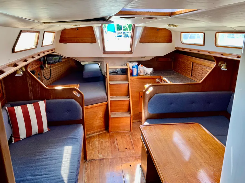Slide: The Image of Interior of 1986 Sabre 36 sailboat with wooden furnishings and blue seating. - 27