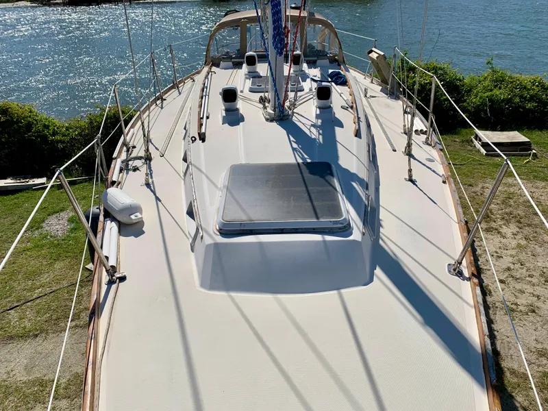 Slide: The Image of 1986 Sabre 36 sailboat deck with clear hatch, docked by the water. - 3