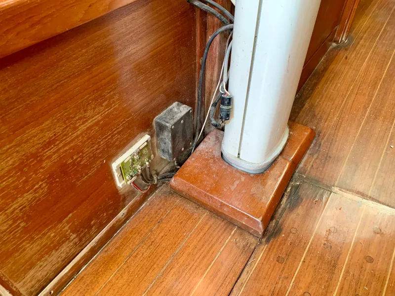 Slide: The Image of 1986 Sabre 36 interior showing wooden flooring and electrical components near a mast base. - 35