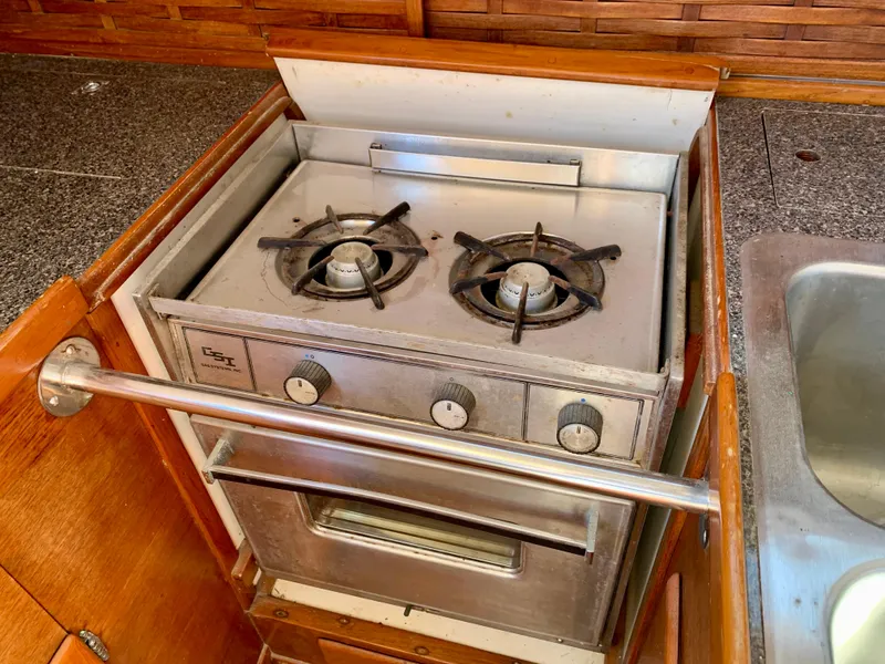 Slide: The Image of Vintage 1986 Sabre 36 yacht kitchen with a two-burner stove and oven. - 36