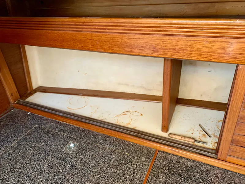 Slide: The Image of 1986 Sabre 36 interior wooden cabinet with open storage space and granite flooring. - 37