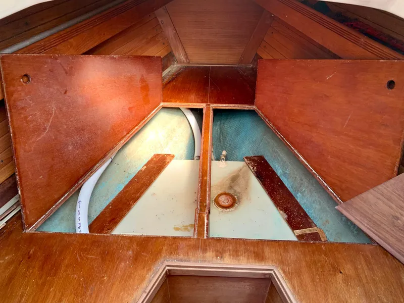 Slide: The Image of Interior view of 1986 Sabre 36 sailboat storage compartment with wooden panels open. - 42