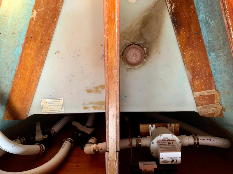 Slide: The Image of Bilge area of 1986 Sabre 36 sailboat with plumbing and pump system. - 43
