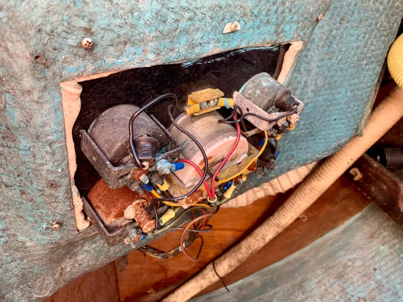 Slide: The Image of Old electrical panel with exposed wiring in a 1986 Sabre 36 boat. - 44
